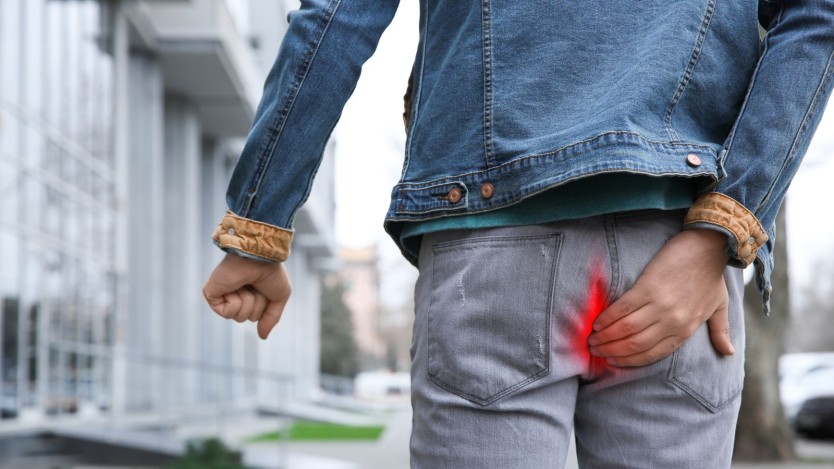 Man in pain due to haemorrhoids