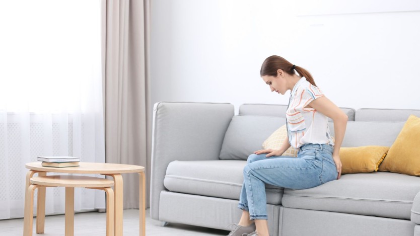 Woman suffering pain from haemorrhoids